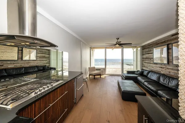 a kitchen with a stove a sink and wooden cabinets