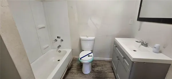 a bathroom with a sink toilet vanity and bathtub