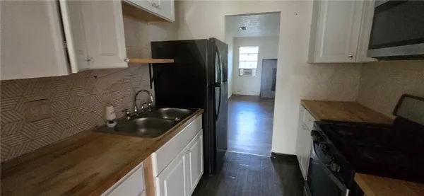 a kitchen with a sink and refrigerator