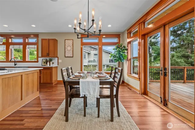 a view of a dining room with furniture wooden floor and chandelier