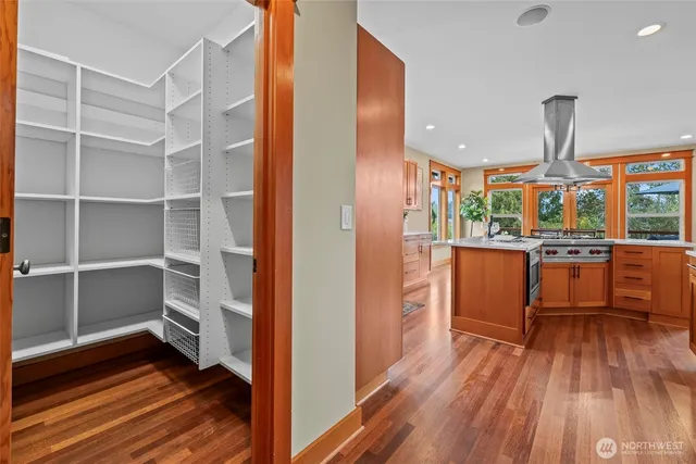 a kitchen view with wooden floor and electronic appliances