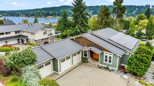 an aerial view of a house with a yard patio and outdoor seating