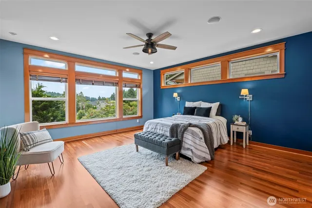 a bedroom with a large bed and a large window