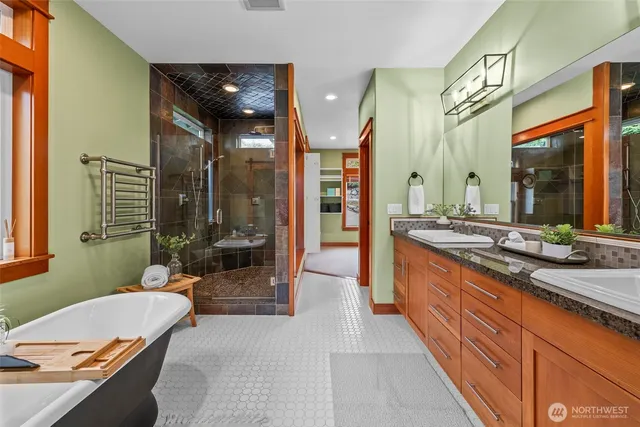 a spacious bathroom with a granite countertop tub sink and mirror