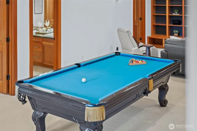 a room with pool table and windows
