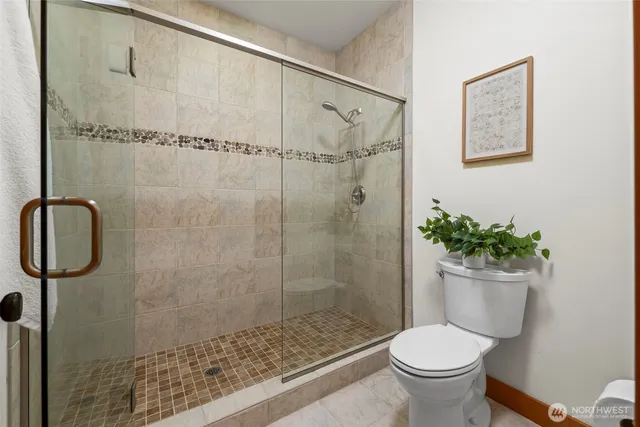 a bathroom with a shower and a toilet