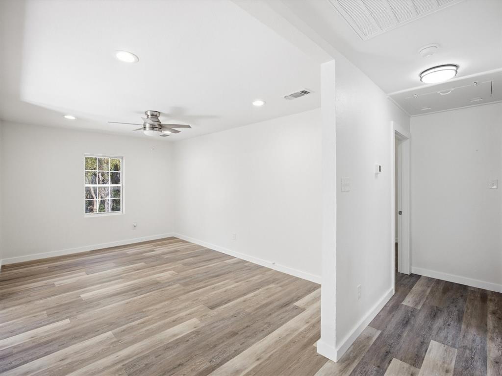 6933 Hatch Road Lake Worth, TX 76135 - Photo 15 of 28 Wood-finish flooring, recessed lighting, ceiling fan, white walls, and a window with muntins
