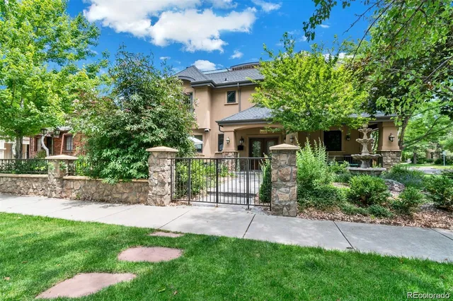 a front view of a house with a garden and plants