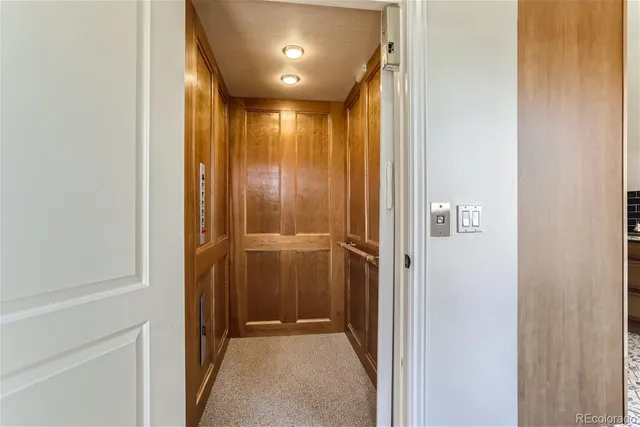 a view of a hallway with a glass door and door