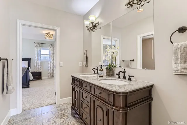 a bathroom with a sink a vanity and a mirror