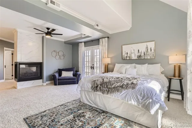 a spacious bedroom with a bed a couch and dresser