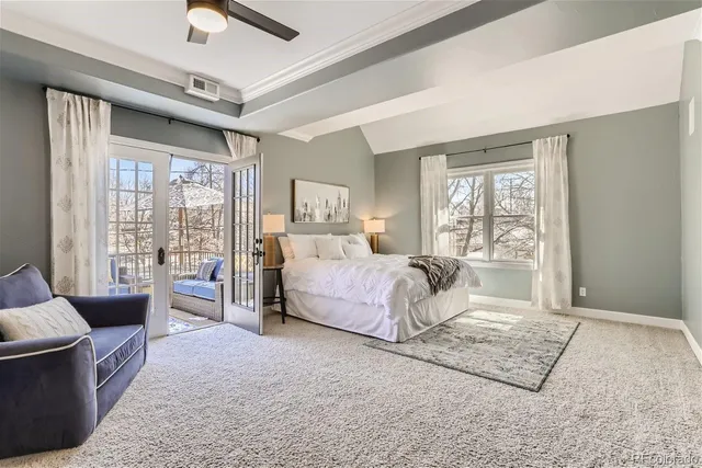 a bedroom with a large bed couch and a window