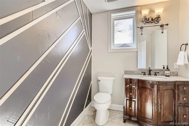 a bathroom with a toilet a sink and a mirror