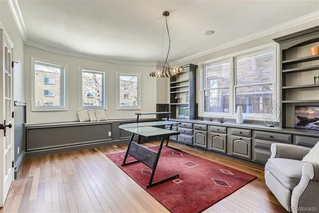 a large kitchen with kitchen island granite countertop a large window a sink and stainless steel appliances