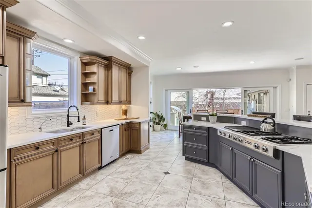 a large kitchen with a stove top oven sink and cabinets
