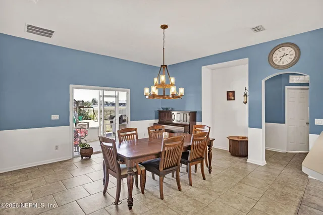 a dining room with a wooden table and chairs