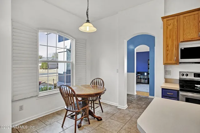 a view of a dining room with furniture window and wooden floor