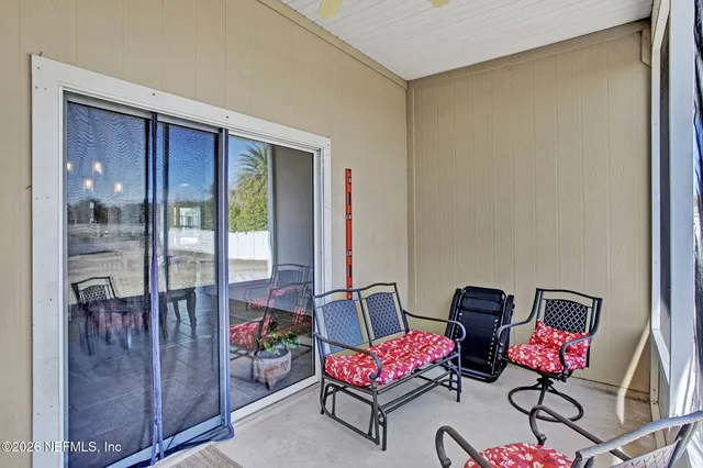 a dining room with furniture a chandelier and wooden floor