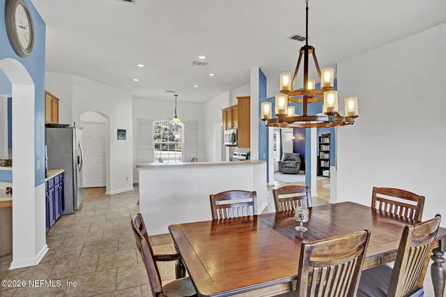 a front view of a house with a garden and plants