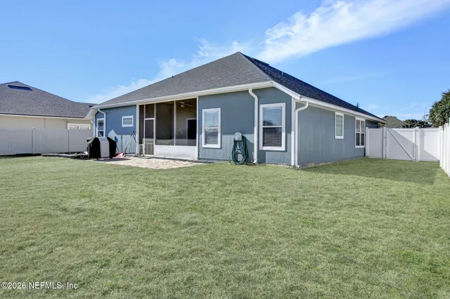 a view of a house with a yard and sitting area