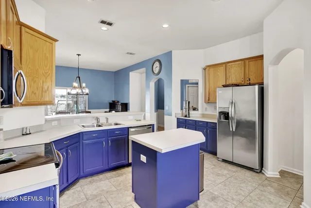 a kitchen with a sink refrigerator and cabinets