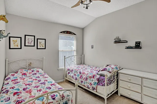 a bedroom with two beds and painted walls