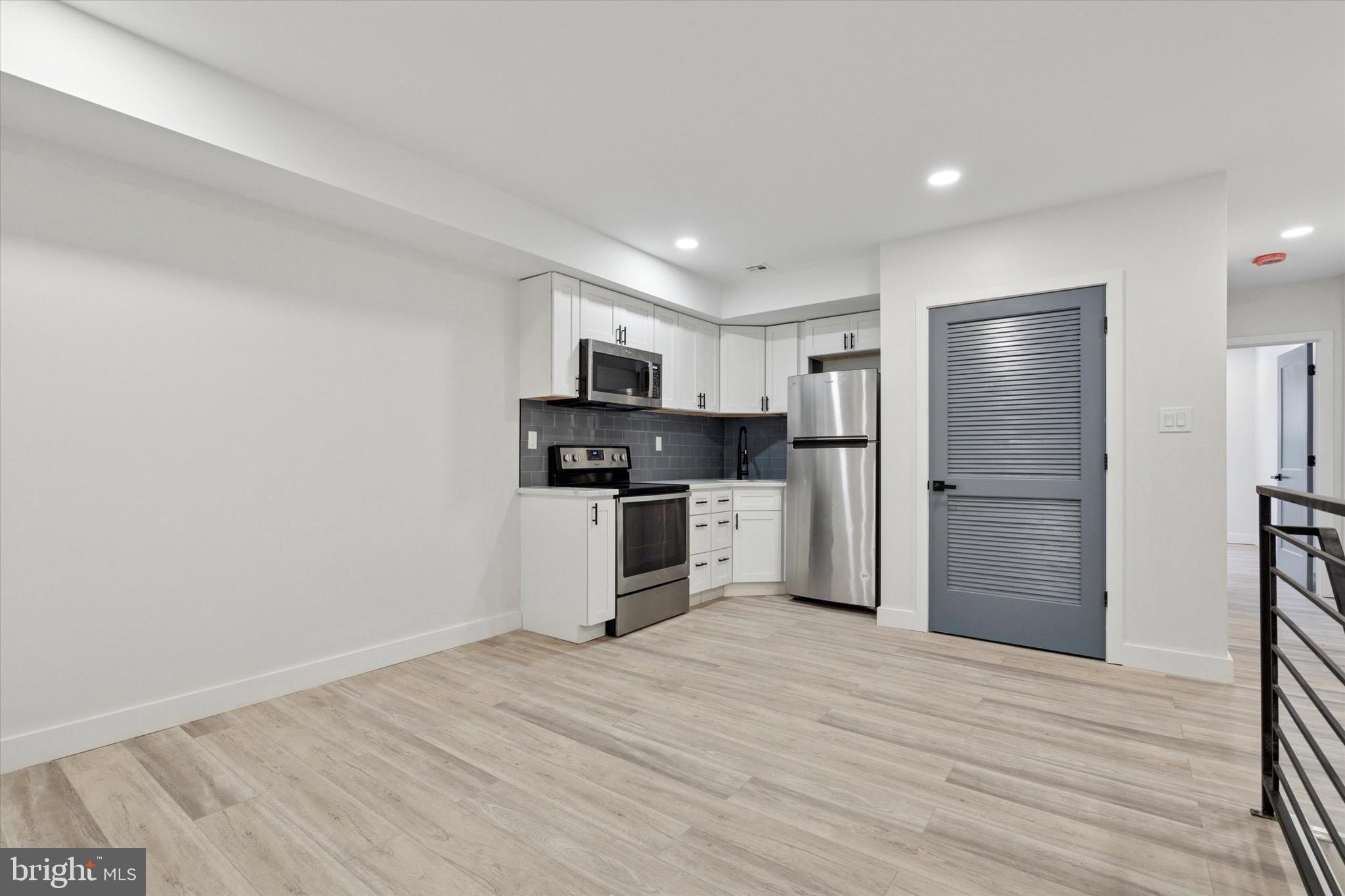 944 West Lycoming Street, Unit B Philadelphia, PA 19140 - Photo 3 of 8 a kitchen with stainless steel appliances a refrigerator and a stove top oven