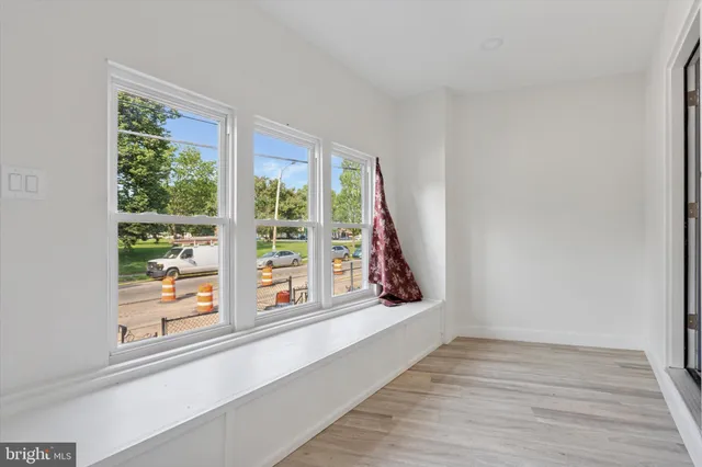 a view of a room that has a large window and front door