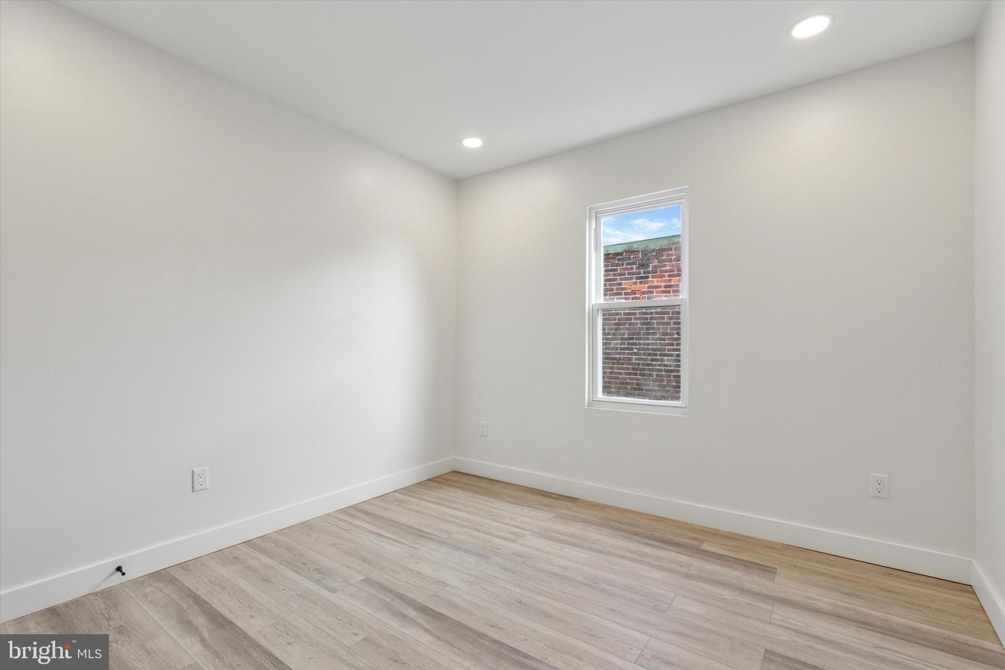 944 West Lycoming Street, Unit B Philadelphia, PA 19140 - Photo 8 of 8 an empty room with wooden floor and windows