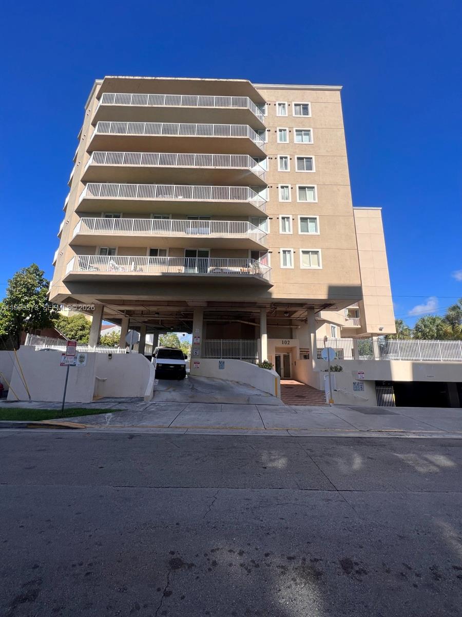 a view of building with parking space