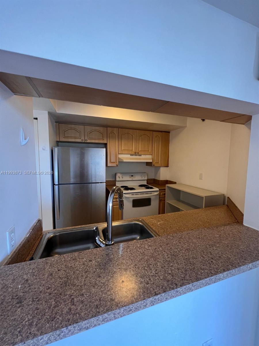 102 Southwest 6th Avenue, Unit 508 Miami, FL 33130 - Photo 12 of 27 a kitchen with a sink a counter space and appliances