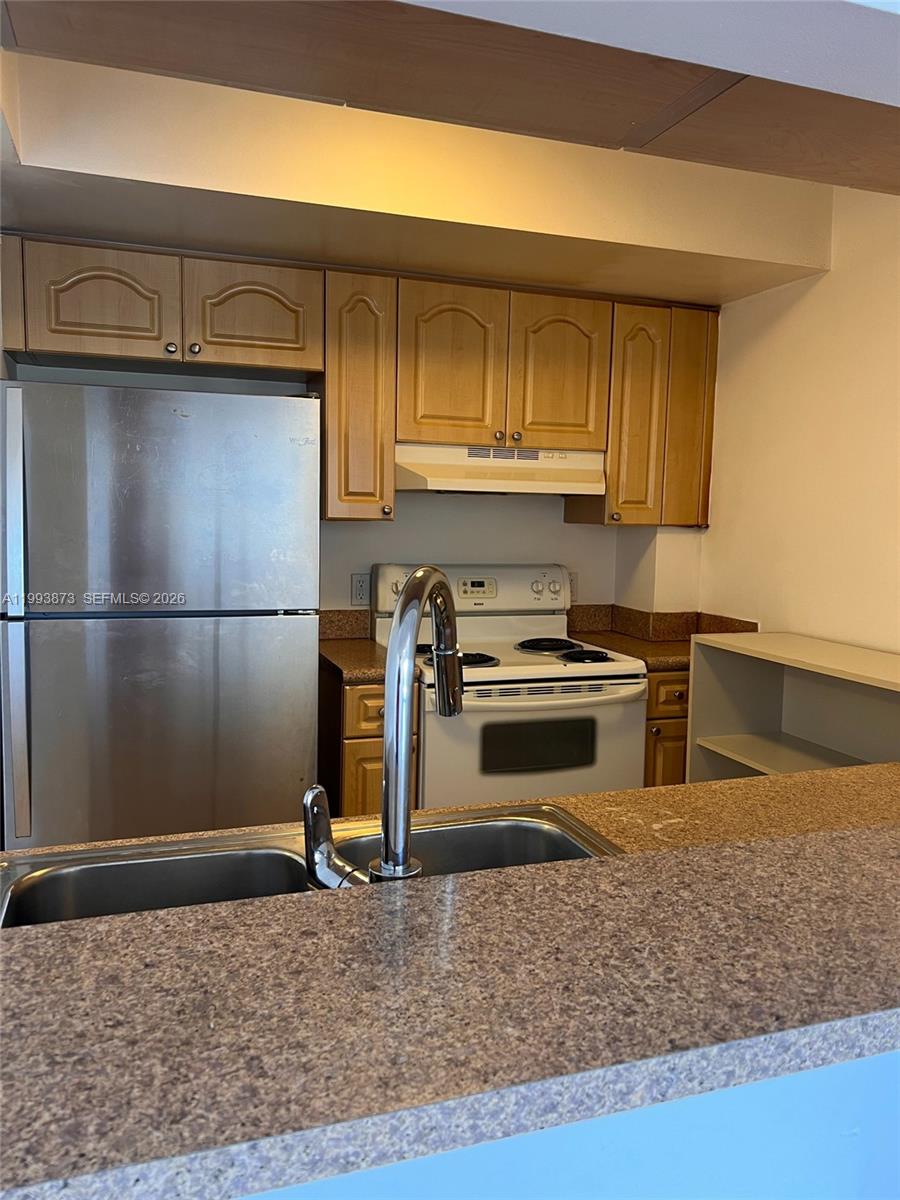 102 Southwest 6th Avenue, Unit 508 Miami, FL 33130 - Photo 14 of 27 a kitchen with a stove and a refrigerator