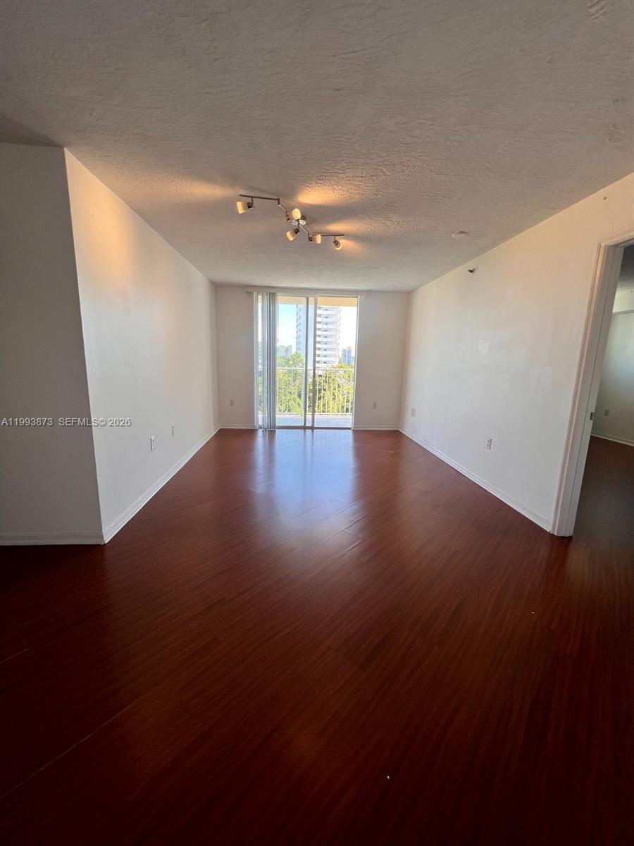 102 Southwest 6th Avenue, Unit 508 Miami, FL 33130 - Photo 10 of 27 an empty room with wooden floor and windows