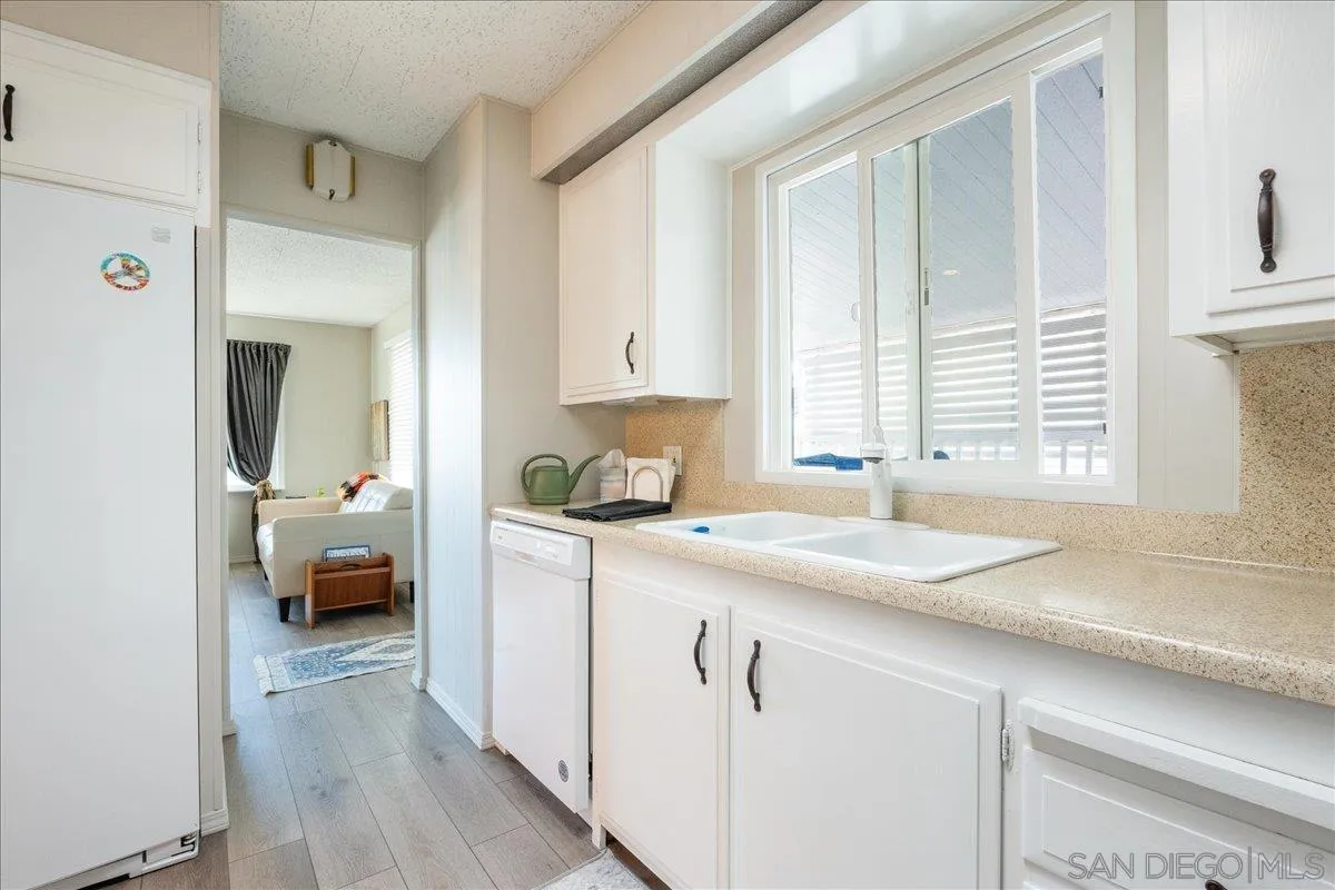 90 Blue Sky Lane Oceanside, CA 92056 - Photo 11 of 31 a kitchen with a sink cabinets and a window