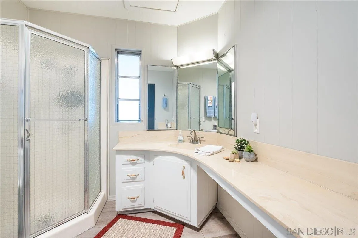 90 Blue Sky Lane Oceanside, CA 92056 - Photo 22 of 31 a bathroom with a sink a mirror and a shower