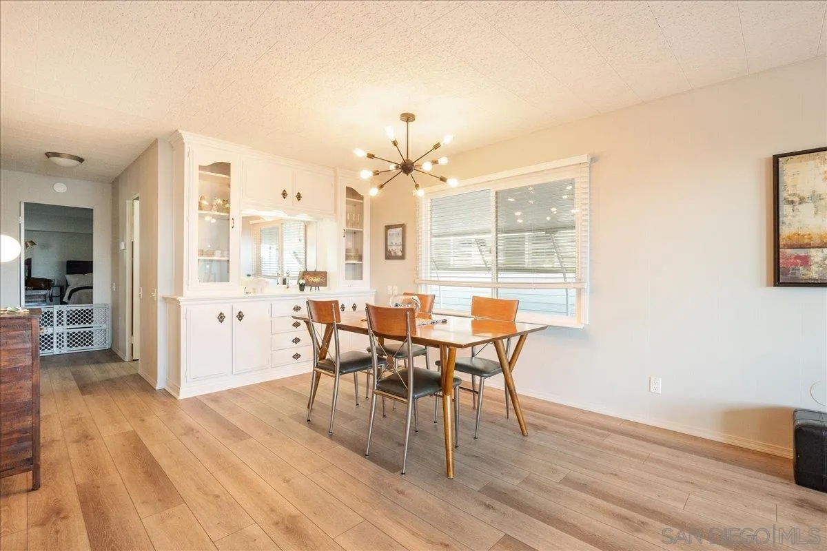 90 Blue Sky Lane Oceanside, CA 92056 - Photo 5 of 31 a view of a dining room with furniture and wooden floor