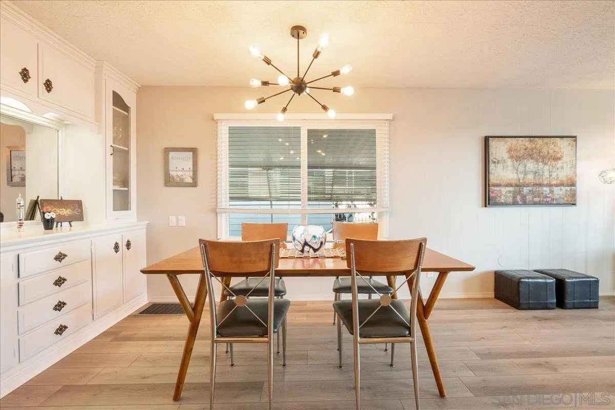 90 Blue Sky Lane Oceanside, CA 92056 - Photo 6 of 31 a view of a dining room with furniture and wooden floor