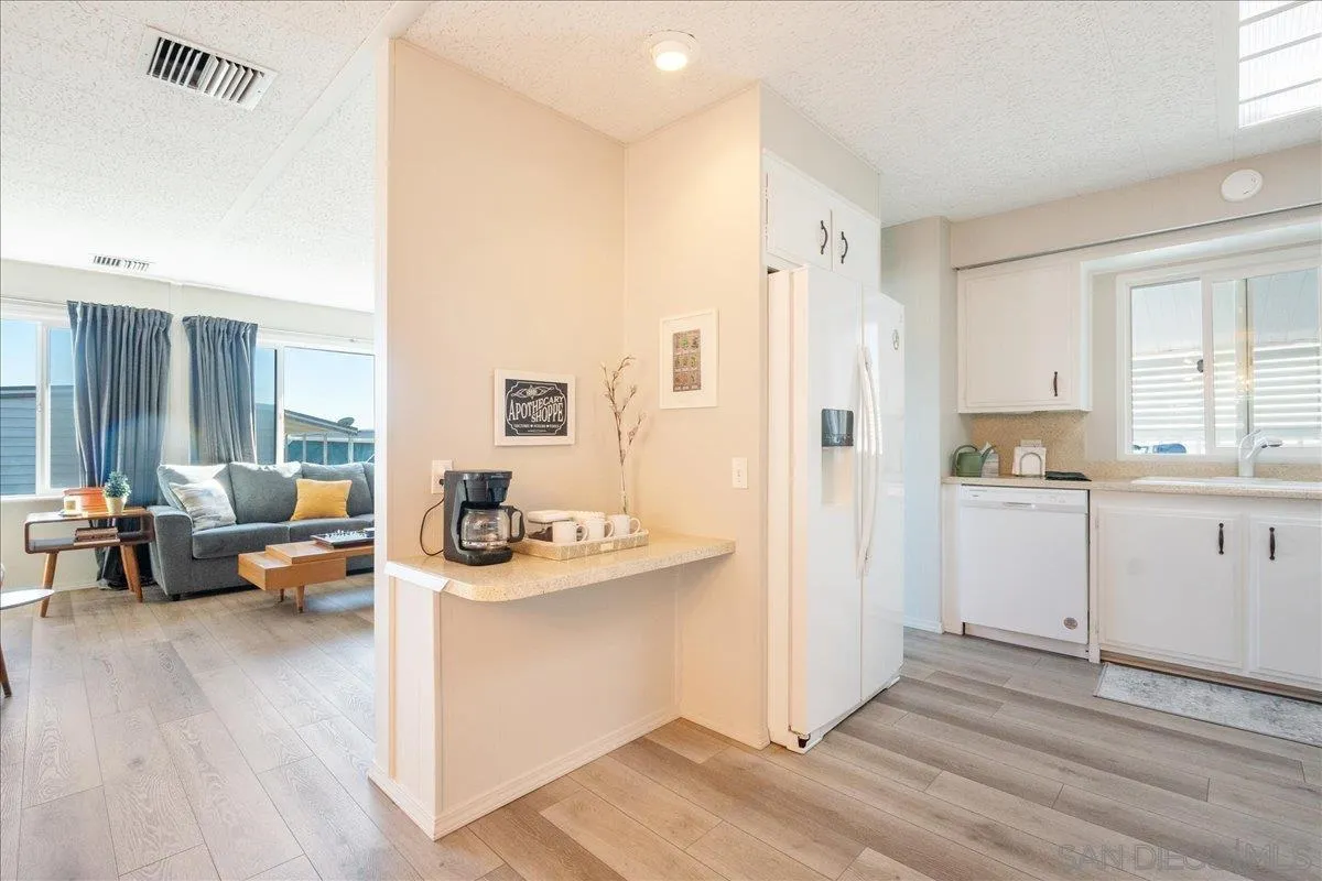 90 Blue Sky Lane Oceanside, CA 92056 - Photo 8 of 31 a view of a living room kitchen and a wooden floor