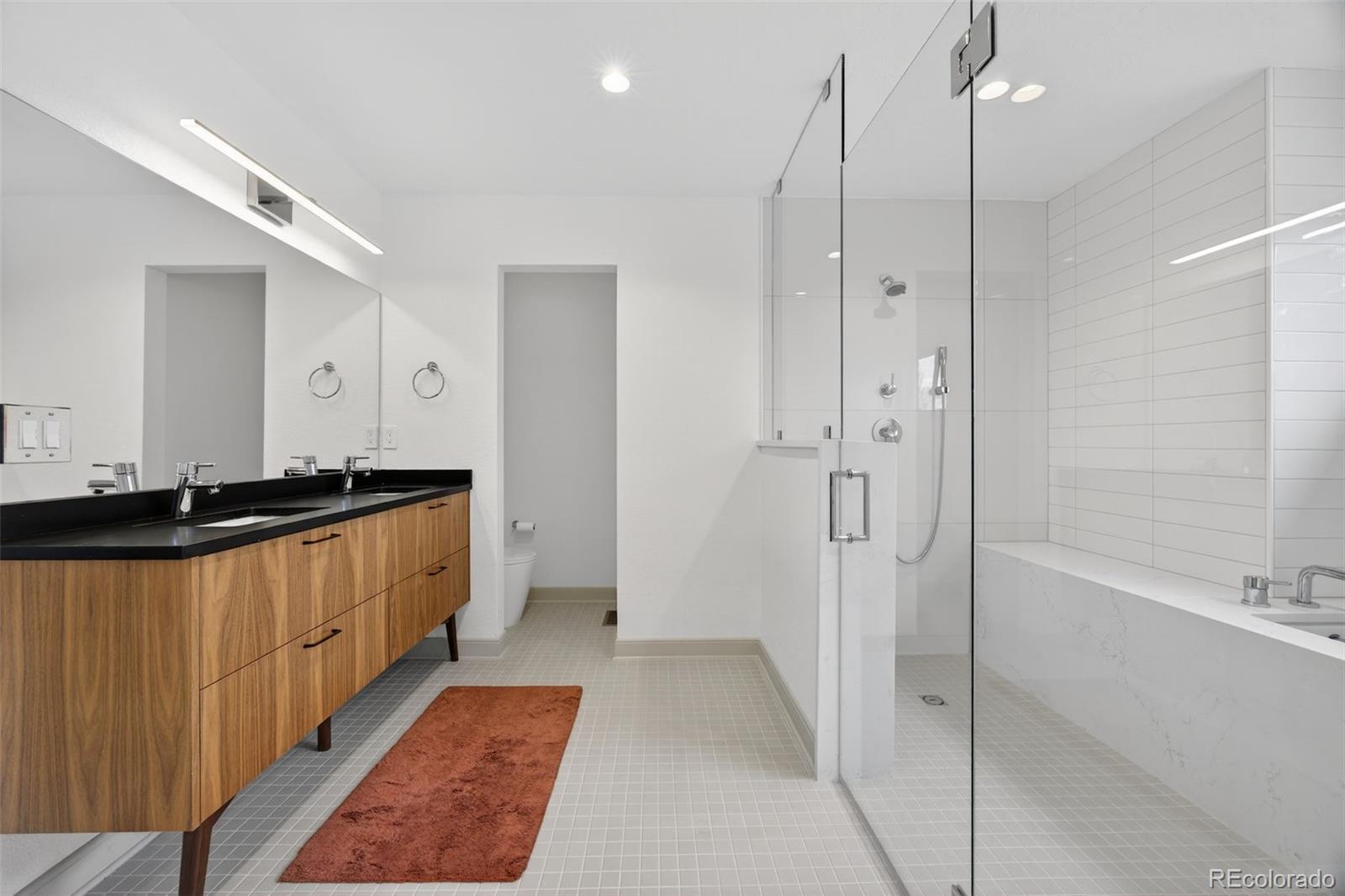 3200 Zephyr Court Wheat Ridge, CO 80033 - Photo 19 of 45 a bathroom with a double vanity sink and a large mirror