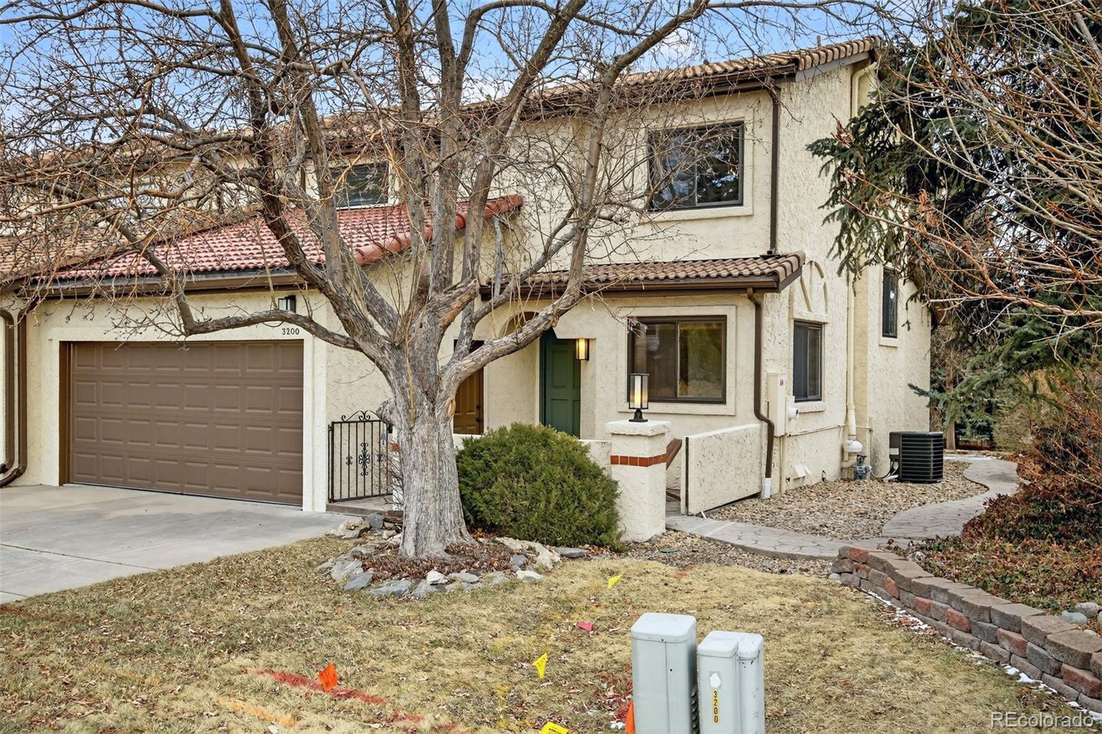 3200 Zephyr Court Wheat Ridge, CO 80033 - Photo 2 of 45 a front view of a house with large trees