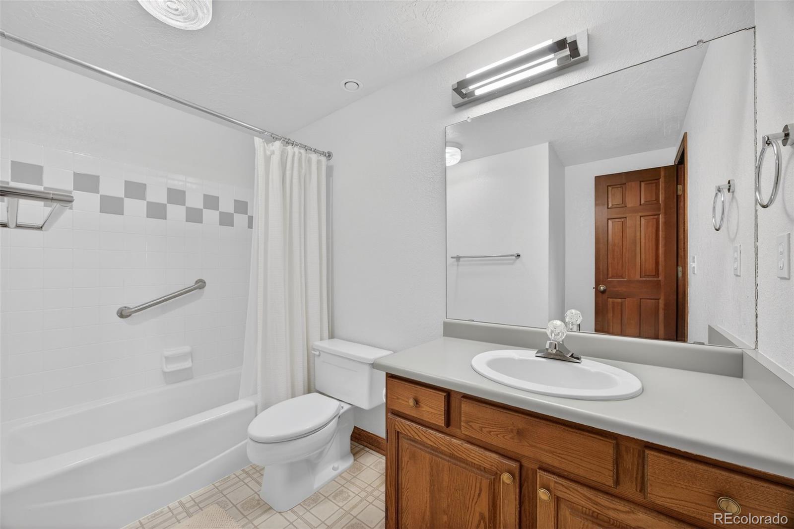 3200 Zephyr Court Wheat Ridge, CO 80033 - Photo 25 of 45 a bathroom with a sink toilet a mirror and shower