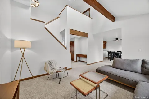 a living room with furniture and stairs