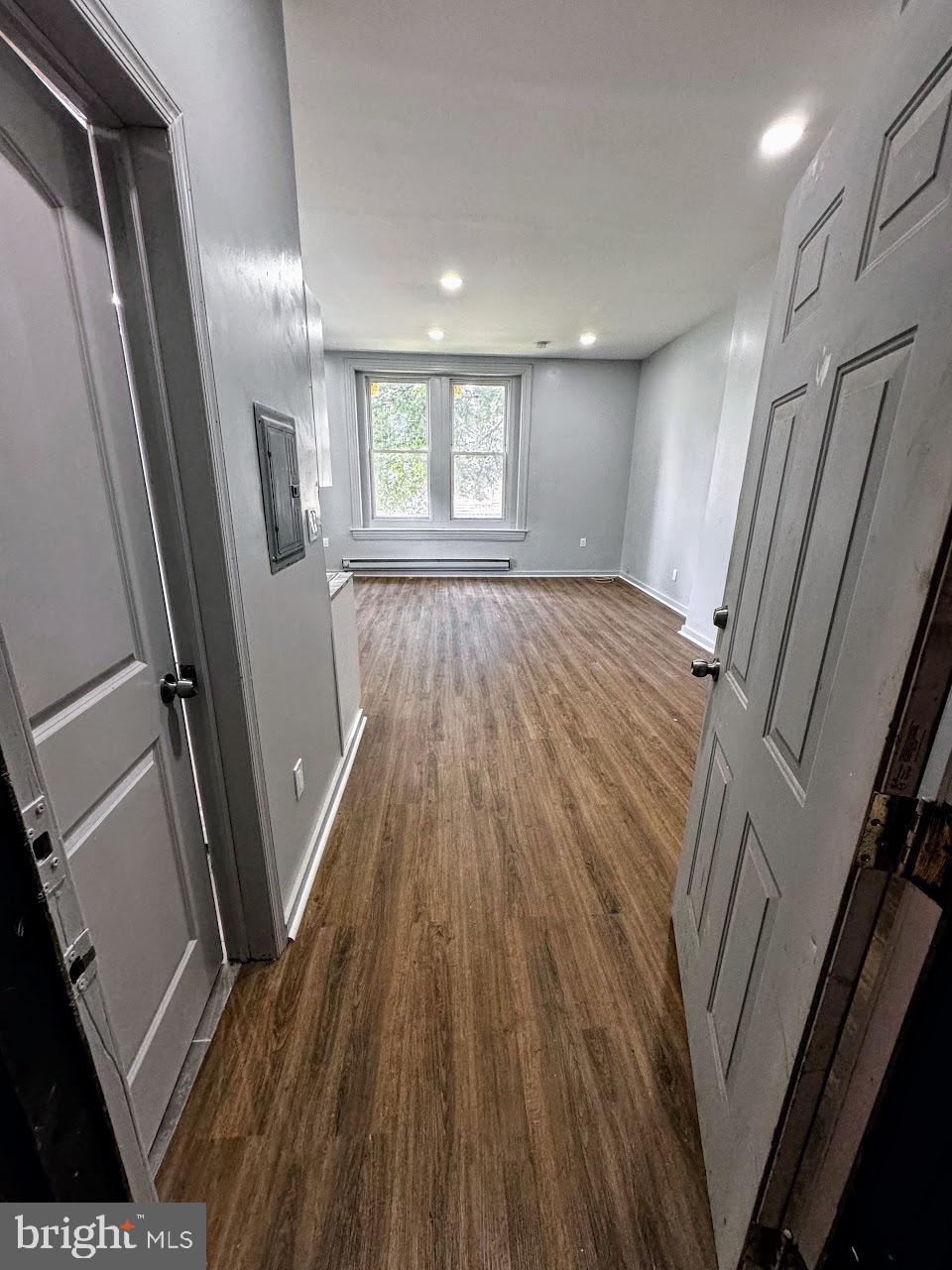 5003 Penn Street, Unit 1F Philadelphia, PA 19124 - Photo 6 of 11 a view of an empty room with wooden floor and a window