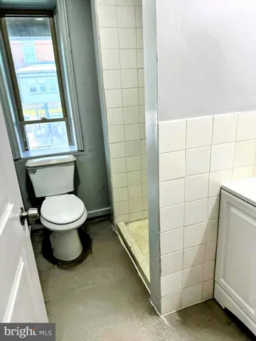 a view of a room with wooden floor and a window