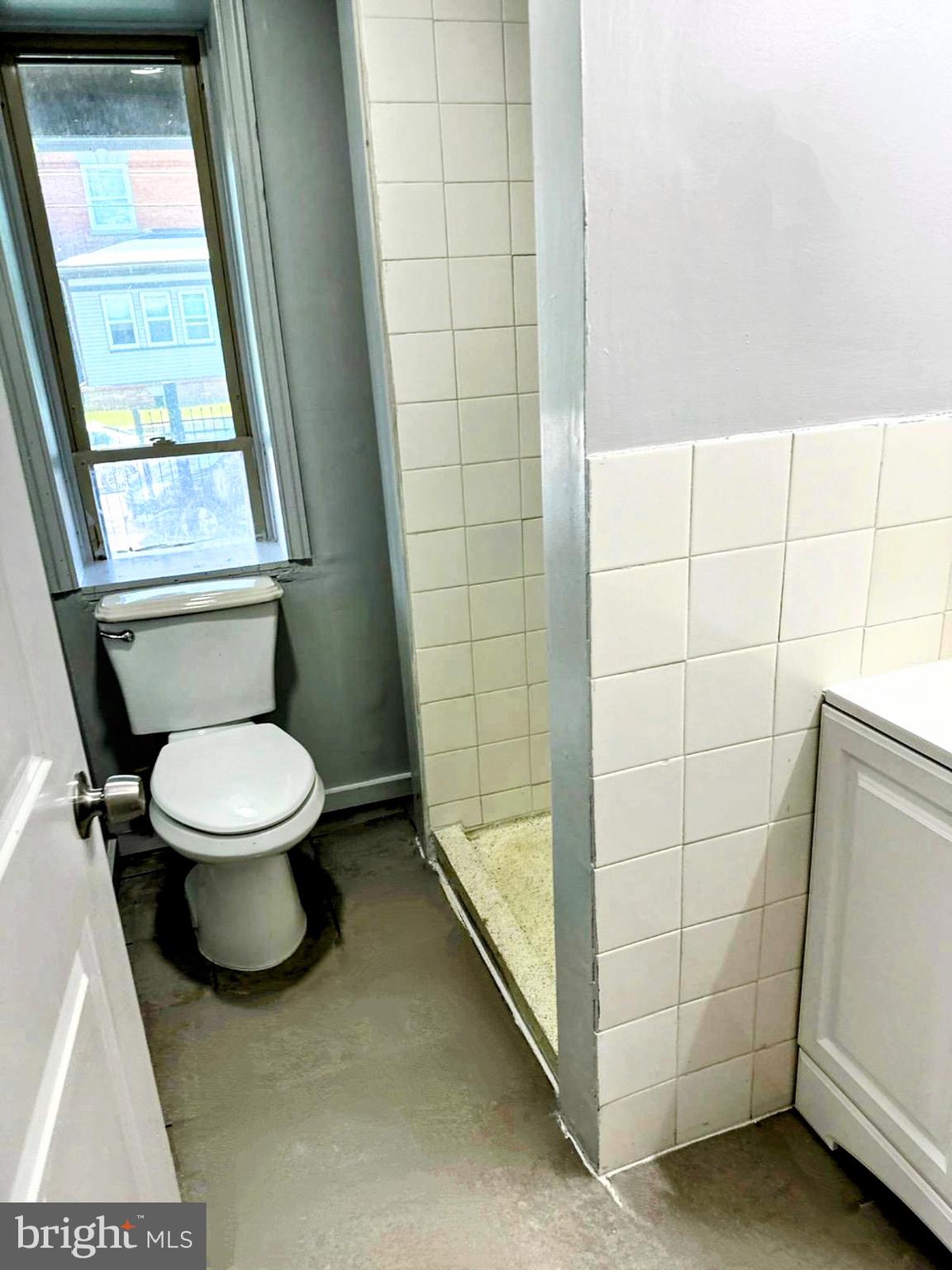 5003 Penn Street, Unit 1F Philadelphia, PA 19124 - Photo 9 of 11 a bathroom with a toilet and a shower