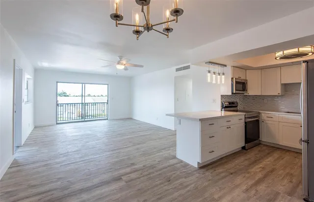 a kitchen with stainless steel appliances a refrigerator and a stove
