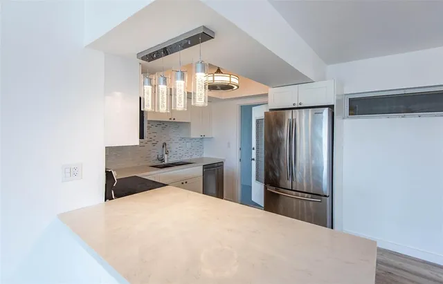 a kitchen with cabinets appliances and a sink