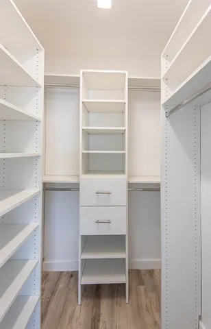 an empty room with windows and closet