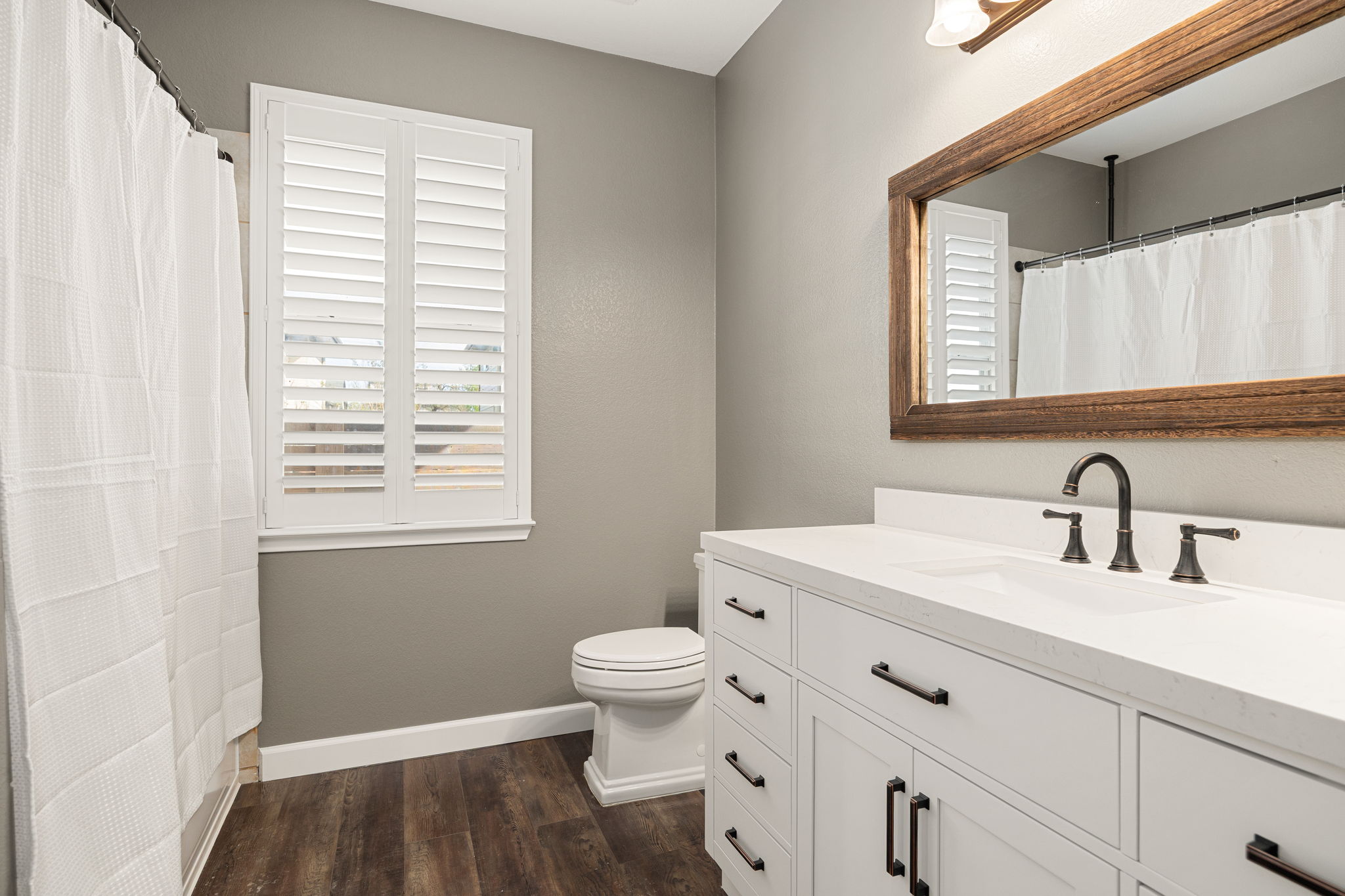 4805 Louis Avenue Austin, TX 78721 - Photo 11 of 23 a bathroom with a sink a toilet and a window
