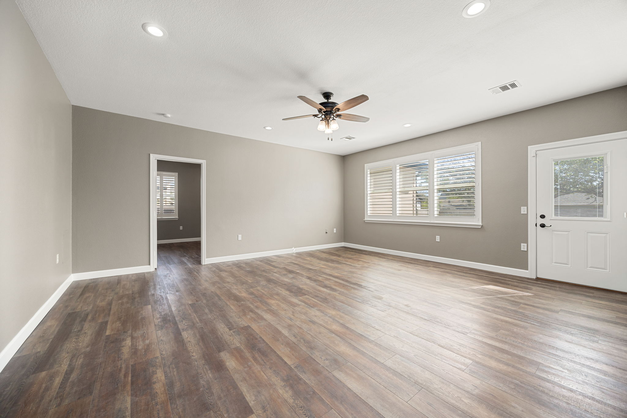 4805 Louis Avenue Austin, TX 78721 - Photo 4 of 23 a view of an empty room with a window and wooden floor